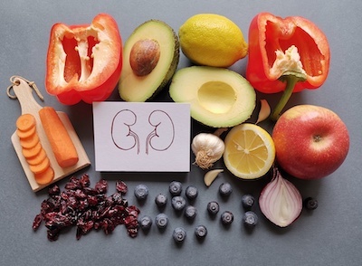 Kidney drawing surrounded by fruits and vegetables