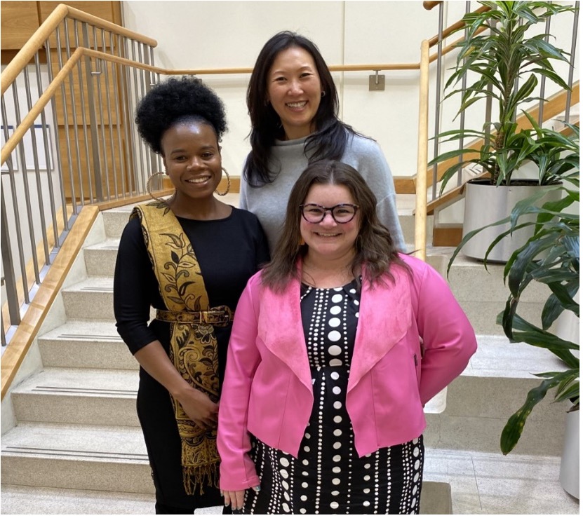 a photo of three women standing on the stairs in the foyer of CINJ