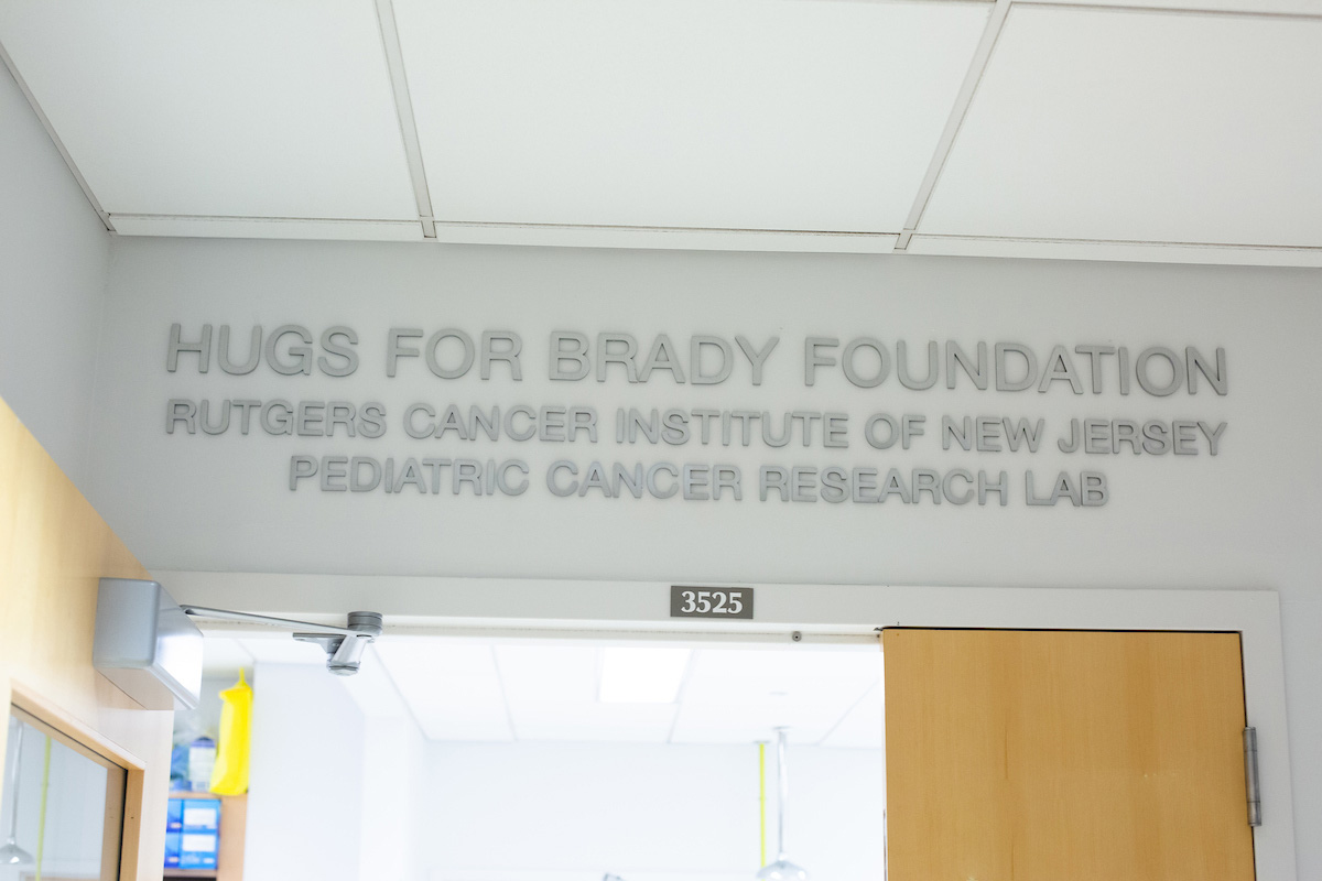 photograph of the words Hugs For Brady Foundation Rutgers Cancer Institute of New Jersey Pediatric Cancer Research Lab hanging above the doors to a research laboratory