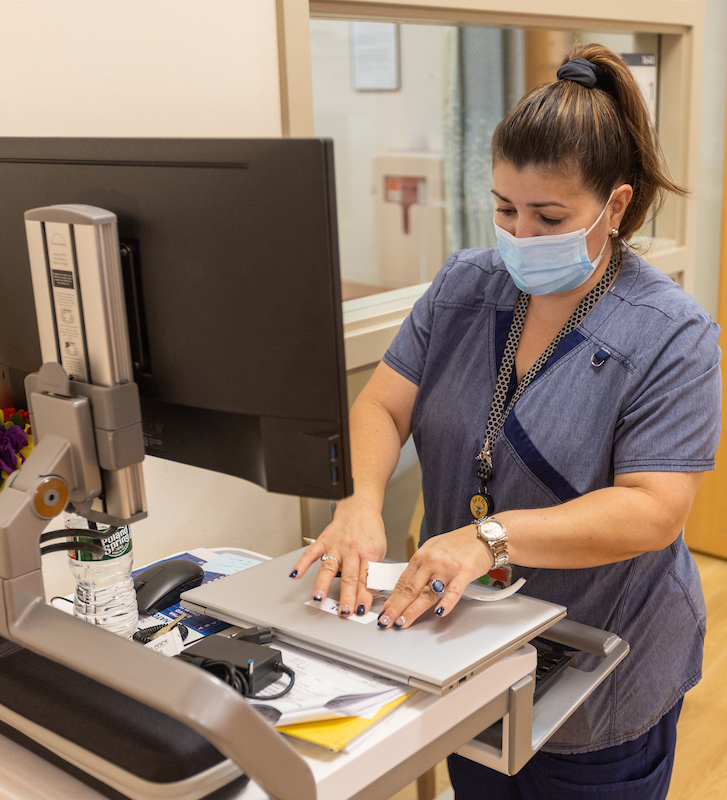 nurse standing at workstation