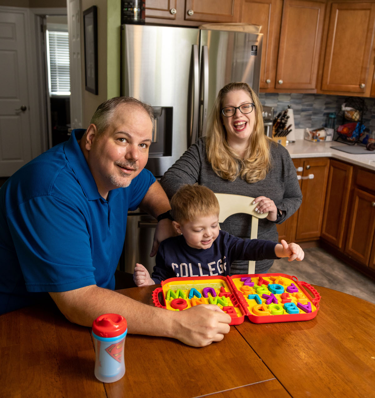 family sitting at wooden table