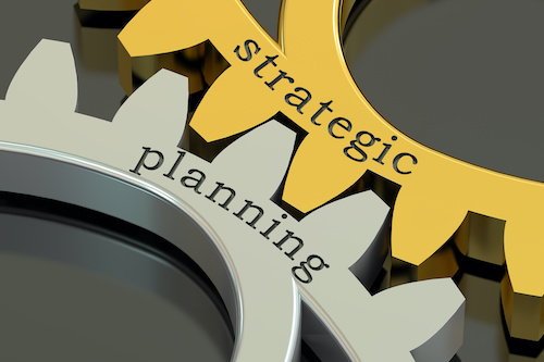 two interlocking gears spelling out strategic planning
