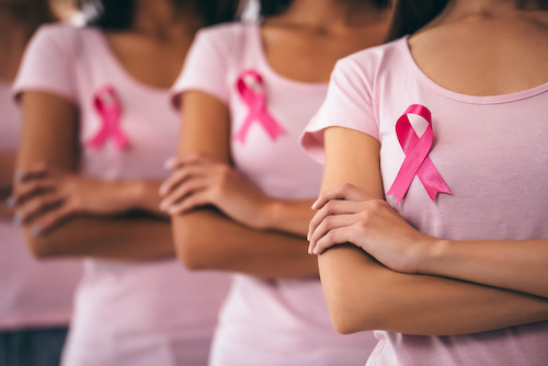 women in pink shirts wearing pink ribbons