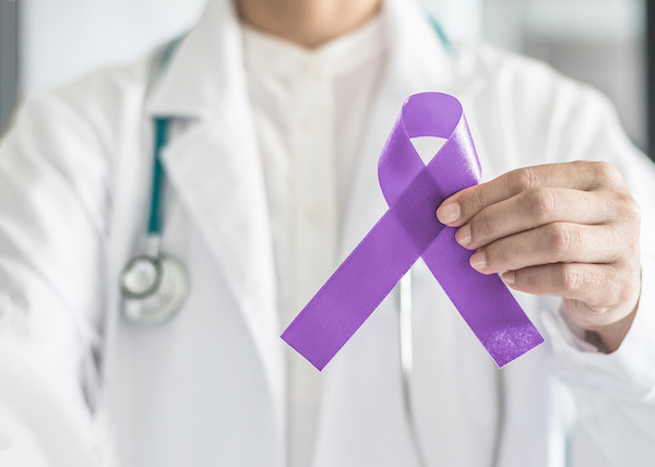 Testicular Cancer Awareness Month ribbon being held