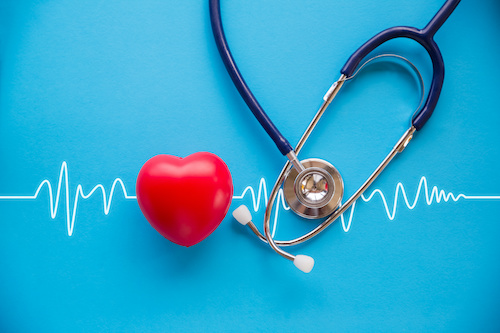 heart and stethoscope on blue background with echocardiogram