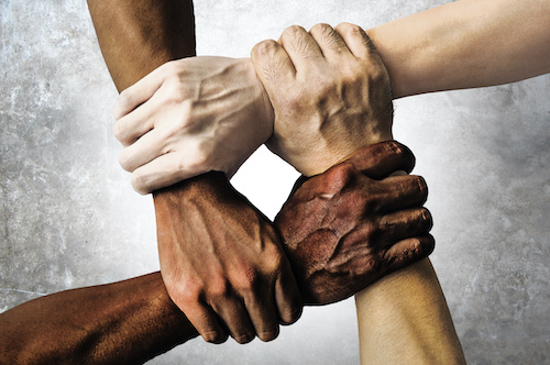 multiracial hands clasped together