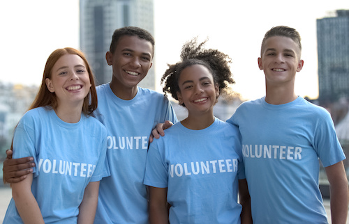 Happy young people volunteer t-shirts posing camera