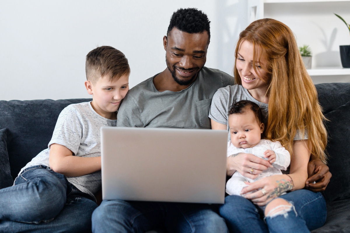 multiracial family sitting around laptop