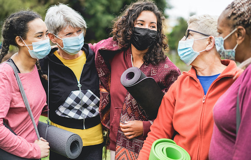 group of multicultural women in exercise clothes and masks