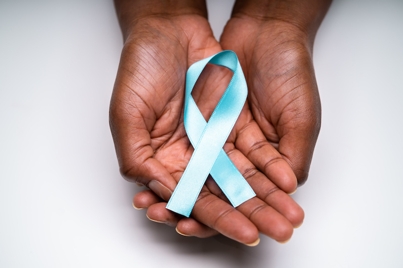 hands holding a cervical cancer awareness ribbon