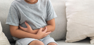 Child holding stomach in pain