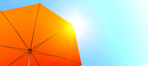 orange sun umbrella against blue sky