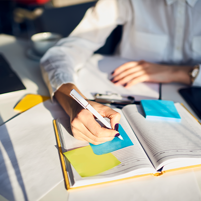 person at desk taking notes