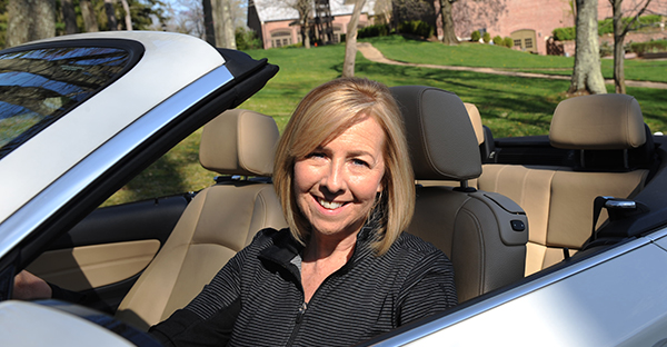 Marcia Bird sitting in a convertible car