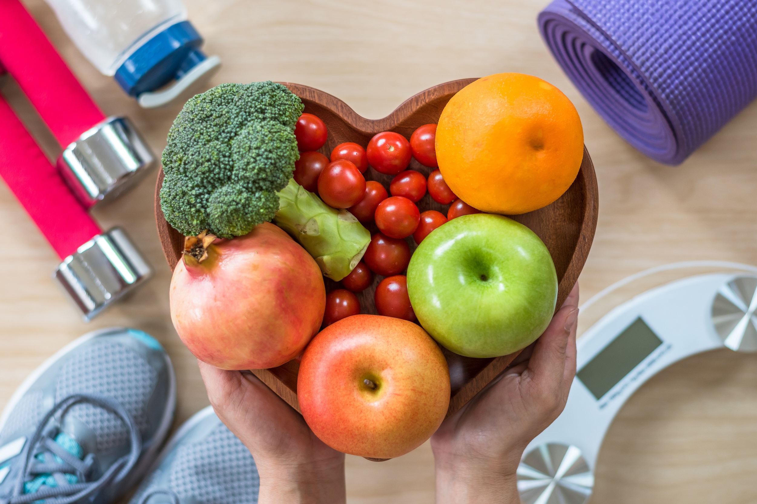 Heart shaped bowl full of fruits and vegetables