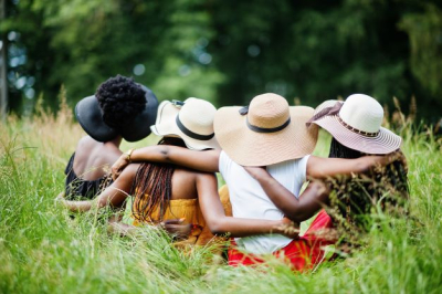 Black women with arms around one another