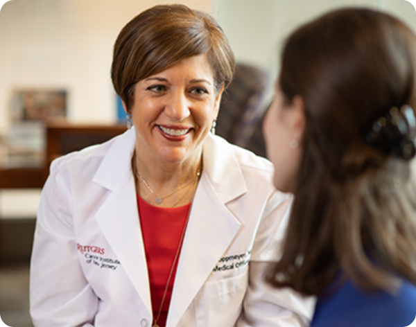 Dr. Toppmeyer sitting across from a female patient