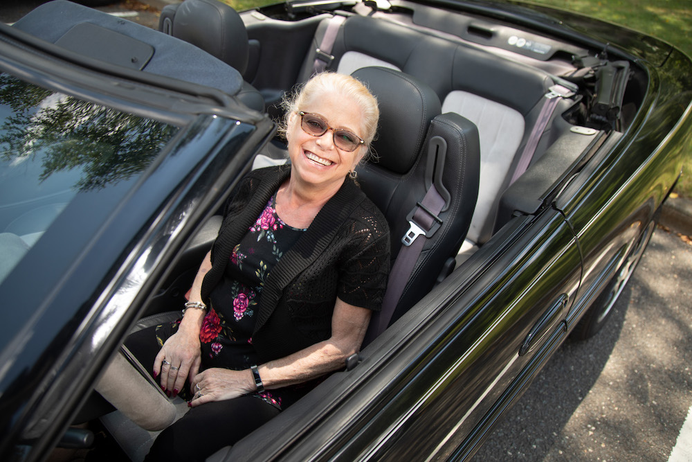 Ruth Hansen sitting in a convertible 