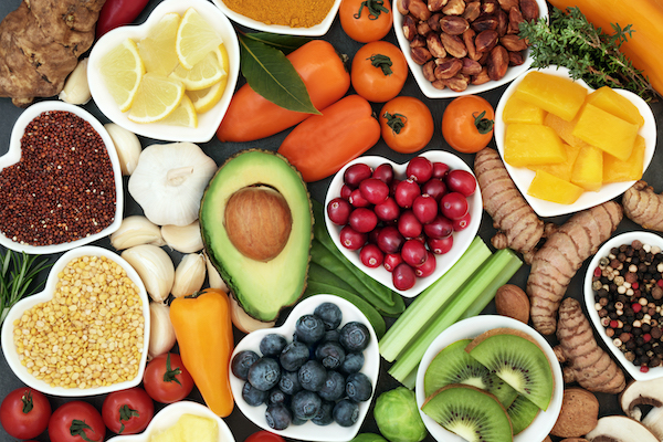 spread of fruits and vegetables in heart shaped dishes