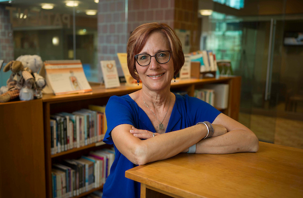 Janet Lasin standing in the library