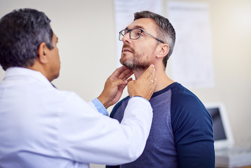 male doctor performing exam on male patient