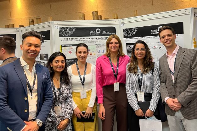 lab investigators in front of poster