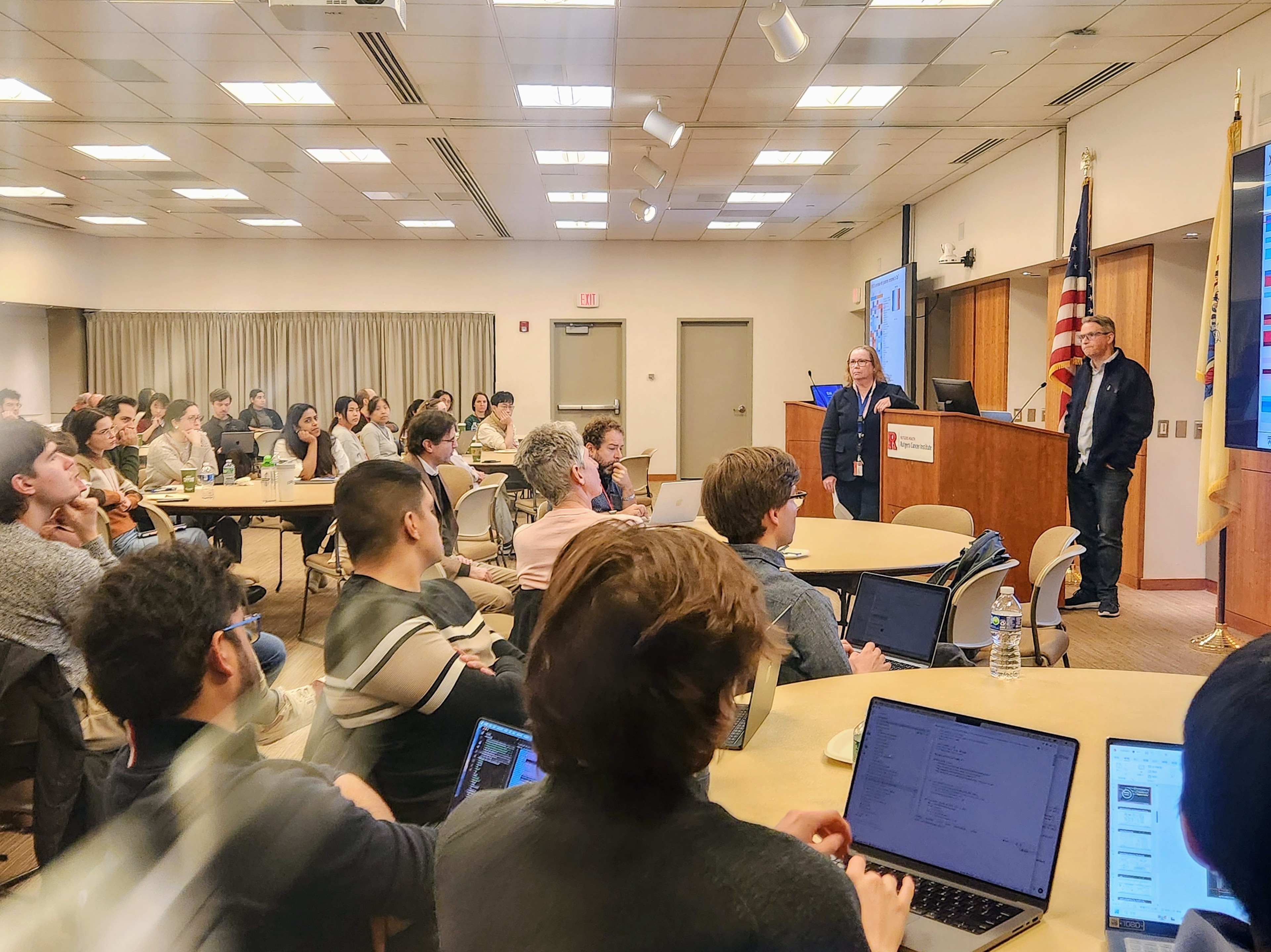 Ludwig cancer researchers sitting in conference room